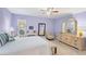 This purple bedroom has a queen bed, tile floors, writing desk, and natural light at 3443 Tallywood Cir # 7061, Sarasota, FL 34237