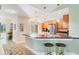 Bright kitchen with stainless steel appliances, a breakfast bar with seating, and modern lighting fixtures at 3443 Tallywood Cir # 7061, Sarasota, FL 34237