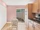 Cozy eat-in kitchen includes a sliding glass door, laminate floors, and light wooden cabinetry at 3443 Tallywood Cir # 7061, Sarasota, FL 34237