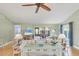 Bright living room with comfortable sofas, ceiling fan, and sliding glass doors to outdoor seating area at 3443 Tallywood Cir # 7061, Sarasota, FL 34237