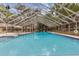 Large screened-in pool area with lounge chairs, offering a relaxing outdoor experience at 3443 Tallywood Cir # 7061, Sarasota, FL 34237