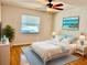 Comfortable bedroom with hardwood floors, bright window, and coastal-themed decor at 4127 3Rd Ave W, Palmetto, FL 34221