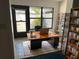 Bright home office space with large windows, modern desk, and built-in shelving at 4127 3Rd Ave W, Palmetto, FL 34221