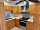 Traditional kitchen featuring wood cabinets, stainless steel appliances, and patterned backsplash at 4127 3Rd Ave W, Palmetto, FL 34221