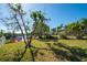 Manicured backyard with views of the water, new landscaping, and new fence at 4419 Mangrove Point Rd, Bradenton, FL 34210