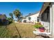 A sunny backyard with a patio, lush lawn, and view of waterfront perfect for outdoor relaxation and entertaining at 4419 Mangrove Point Rd, Bradenton, FL 34210
