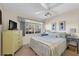 Comfortable bedroom with a ceiling fan and large window with lovely view at 4419 Mangrove Point Rd, Bradenton, FL 34210