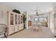 Bright dining room with elegant china cabinet, table setting, and view of the enclosed porch and pool at 4419 Mangrove Point Rd, Bradenton, FL 34210