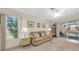 Bright living room with neutral tones, a comfortable sofa, and views to the pool area for relaxation and enjoyment at 4419 Mangrove Point Rd, Bradenton, FL 34210