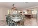 Elegant dining room with seating for ten, modern lighting fixture, and views to a bright, airy kitchen at 4510 Banan Pl, Sarasota, FL 34242