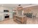 Modern kitchen with stainless steel appliances, center island, and views into the dining area at 4510 Banan Pl, Sarasota, FL 34242