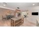 Bright open concept floor plan with wooden floors, dining and living area featuring an island and seating at 4510 Banan Pl, Sarasota, FL 34242