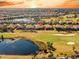 Aerial view of the community showcasing lush landscaping, golf course, and picturesque lakes at sunset at 4745 Benito Ct, Lakewood Ranch, FL 34211