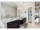 Bright bathroom with double vanity, granite countertops, and a decorative mirror, showcasing a modern design at 4745 Benito Ct, Lakewood Ranch, FL 34211