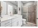 Modern bathroom with double sink vanity, a large glass shower, neutral color scheme, and tiled floors at 4745 Benito Ct, Lakewood Ranch, FL 34211