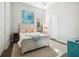 Cozy bedroom with a bed dressed in starfish pillows and ocean art, creating a relaxing coastal theme at 4745 Benito Ct, Lakewood Ranch, FL 34211