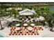 Aerial view of a community pool with a bar and lounge chairs surrounded by lush tropical landscaping at 4745 Benito Ct, Lakewood Ranch, FL 34211