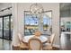 Bright dining area features a decorative light fixture with views of the golf course and patio at 4745 Benito Ct, Lakewood Ranch, FL 34211