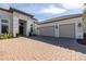 Beautiful home exterior showing three-car garage, covered entry and manicured lawn at 4745 Benito Ct, Lakewood Ranch, FL 34211