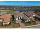 Beautiful single-Gathering home with manicured lawn, paved driveway, and view of the golf course and lake at 4745 Benito Ct, Lakewood Ranch, FL 34211