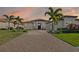Beautiful one-story home at sunset featuring well-manicured landscaping and a neutral color scheme at 4745 Benito Ct, Lakewood Ranch, FL 34211