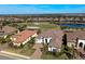 Beautiful single-Gathering home with manicured lawn, paved driveway, and view of the golf course and lake at 4745 Benito Ct, Lakewood Ranch, FL 34211