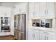 Well-equipped kitchen with stainless steel refrigerator, double ovens, and breakfast bar at 4745 Benito Ct, Lakewood Ranch, FL 34211