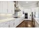 Modern kitchen with white cabinets, stainless steel appliances, and hardwood floors at 4745 Benito Ct, Lakewood Ranch, FL 34211