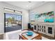 Bright living room with hardwood floors, an outdoor view, a decorative cabinet and a coffee table at 4745 Benito Ct, Lakewood Ranch, FL 34211