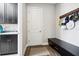 Mudroom featuring black cabinetry, a bench, and wooden coat rack, offering practical entryway storage solutions at 4745 Benito Ct, Bradenton, FL 34211