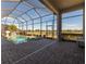 Screened-in pool area with a spa and golf course view, ideal for relaxation and recreation at 4745 Benito Ct, Lakewood Ranch, FL 34211