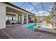 A beautiful screened-in swimming pool, with an outdoor kitchen, and covered seating area at 4745 Benito Ct, Lakewood Ranch, FL 34211