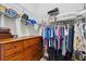 Functional closet with wood dresser, wire shelving, and hanging rods, offering ample storage space at 4745 Benito Ct, Lakewood Ranch, FL 34211