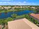 Aerial view of the beautiful lake and neighborhood highlighting tile roofs at 531 Latitude Ln, Osprey, FL 34229