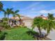 Charming single-story home with lush landscaping, palm trees, and a well-manicured lawn at 531 Latitude Ln, Osprey, FL 34229
