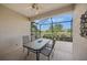 Screened lanai overlooking the lake, with an outdoor dining set and ceiling fan at 531 Latitude Ln, Osprey, FL 34229