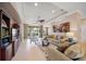 Spacious living room with tray ceilings, neutral decor, and sliding glass doors to the patio at 531 Latitude Ln, Osprey, FL 34229