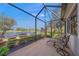 Relaxing screened-in patio overlooking a serene pond and lush landscaping at 531 Latitude Ln, Osprey, FL 34229