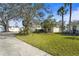 Two-story home with attached garage, manicured lawn and palm trees at 5561 Burnt Branch Cir, Sarasota, FL 34232