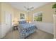 Cozy bedroom with a floral comforter, complemented by a ceiling fan and natural light at 557 Marsh Creek Rd, Venice, FL 34292