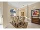 Bright dining room featuring a glass table with seating for six and decorative rug at 557 Marsh Creek Rd, Venice, FL 34292