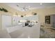 Bright kitchen featuring white cabinets, a breakfast bar, and stainless steel appliances at 557 Marsh Creek Rd, Venice, FL 34292