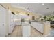 Spacious kitchen with white cabinetry, stainless steel appliances, and center island at 557 Marsh Creek Rd, Venice, FL 34292
