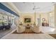 Inviting living room with tile flooring, comfortable seating, and sliding glass doors at 557 Marsh Creek Rd, Venice, FL 34292