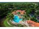 Gorgeous community pool surrounded by palm trees, lounge chairs, and a clubhouse with ample parking at 557 Marsh Creek Rd, Venice, FL 34292