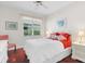 Cozy bedroom with cherry wood floors, white walls, and a window view at 6416 Wentworth Xing, University Park, FL 34201