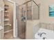 Well-maintained bathroom featuring a glass-enclosed shower and soaking tub at 9214 Raes Creek Pl, Palmetto, FL 34221
