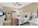 Comfortable bedroom with white furniture, ample storage, and a ceiling fan with light fixture at 9214 Raes Creek Pl, Palmetto, FL 34221