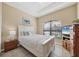 Comfortable bedroom with white furniture and natural lighting from window at 9214 Raes Creek Pl, Palmetto, FL 34221
