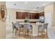 Kitchen island with granite countertops and seating, complemented by stainless steel appliances at 9214 Raes Creek Pl, Palmetto, FL 34221